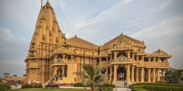 Somnath Temple (Gujarat) at dusk with golden-lit architecture by the Arabian Sea